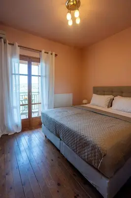 a bedroom with a bed and a large window at Mountain View Villa, by the Pool,Aris in Próvarma