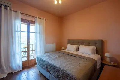 a bedroom with a bed and a large window at Mountain View Villa, by the Pool,Aris in Próvarma