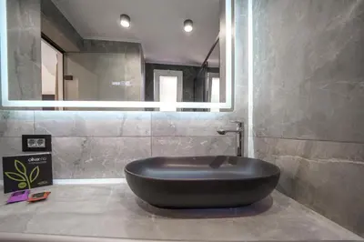 a large black bath tub in a bathroom at OLYMPIA Luxury Apartment in Chania Town