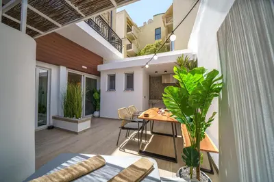 an open balcony with a table and chairs in a house at OLYMPIA Luxury Apartment in Chania Town