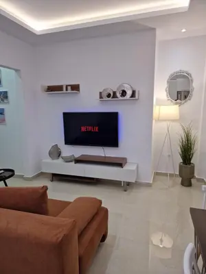 a living room with a tv on a white wall at Thomas & Lukas Apartment in Chania Town