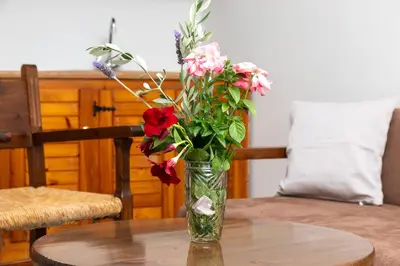 a vase filled with flowers sitting on a table at Lyria Hotel Apartments in Stalos