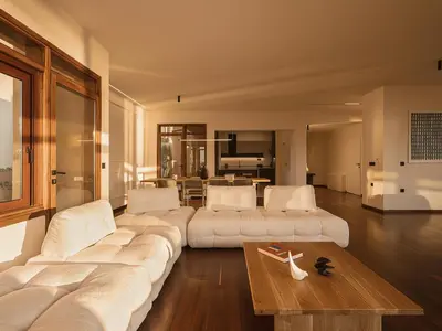 a living room with a large white couch and a table at Aeri Residence in Chania Town
