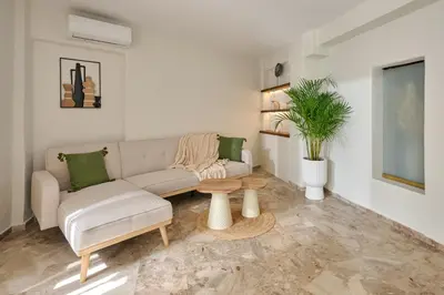 a living room with a couch and a table at Atria Serenity Stay in Chania Town