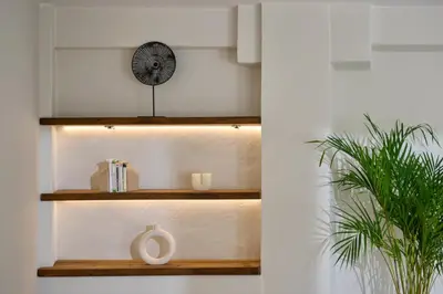 a shelf with a clock and a plant at Atria Serenity Stay in Chania Town