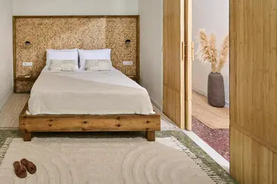 a bedroom with a bed and a door to a room at Atria Serenity Stay in Chania Town