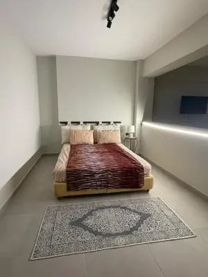 a bedroom with a bed with a rug on the floor at Quiet Nest apartment in Koumpeli