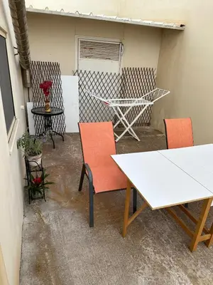 a patio with two tables and chairs and a table at Quiet Nest apartment in Koumpeli