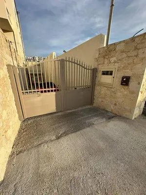 a gate on the side of a building at Quiet Nest apartment in Koumpeli