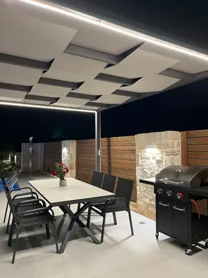 a dining room with a table and a grill at Amare suite 2 in Perivólia