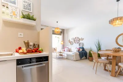 a kitchen and a living room with a table at Kymvari - Stunning sea view-elegant apt-infinity shared pool in Kalyves