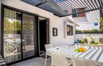 a dining room with a table and chairs on a patio at The Nest in Chania Town