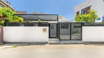 a fence with black and white gates in front of a building at The Nest in Chania Town