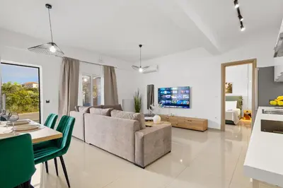 a living room with a couch and a table at Palea Luxury Living in Galatás