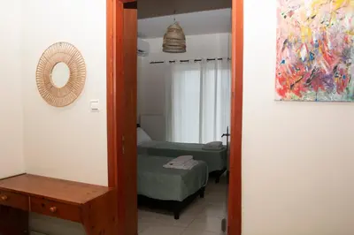a mirror in a room with a bedroom with a bed at Souda Bay View Retreat in Souda