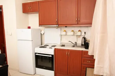 a kitchen with a white refrigerator and a sink at Souda Bay View Retreat in Souda