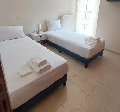 two beds sitting next to each other in a bedroom at Souda Bay View Retreat in Souda