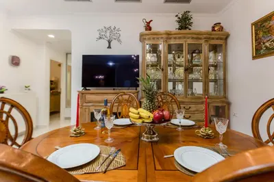 a dining room with a wooden table with bananas on it at Theodosia Heritage Residence in Kissamos