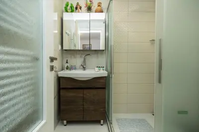 a bathroom with a sink and a shower at Theodosia Heritage Residence in Kissamos