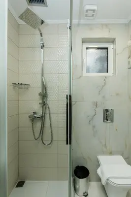 a bathroom with a shower with a toilet and a sink at Theodosia Heritage Residence in Kissamos