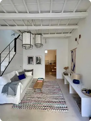 a living room with a white couch and a rug at Filoi Rooftop Boutique House,5pax in Chania Town