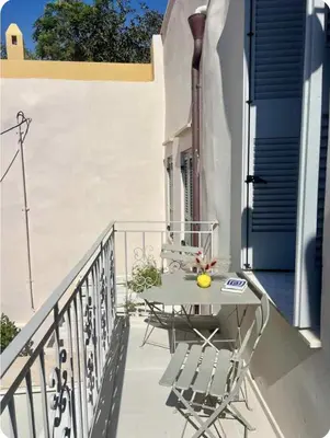 a table and chairs sitting on a balcony at Filoi Rooftop Boutique House,5pax in Chania Town