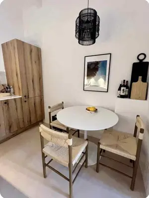 a dining room with a white table and chairs at Filoi Rooftop Boutique House,5pax in Chania Town