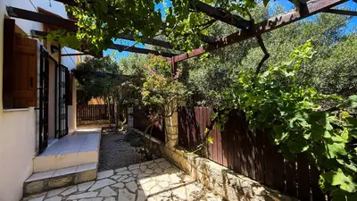 a walkway leading to a house with a fence at SeawoodBreeze - Sea view and Quiet Escape in Tavronitis