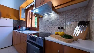 a kitchen with a sink and a stove top oven at SeawoodBreeze - Sea view and Quiet Escape in Tavronitis