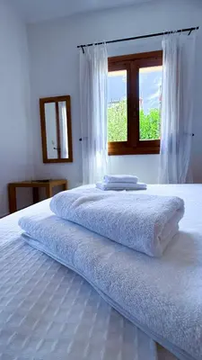 a large white bed with a window in a bedroom at SeawoodBreeze - Sea view and Quiet Escape in Tavronitis
