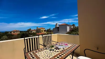 a table and chairs on a balcony with a view at SeawoodBreeze - Sea view and Quiet Escape in Tavronitis