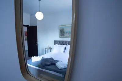 a mirror reflection of a bed in a bedroom at Be Crete - Villa Del Sol in Chania Town