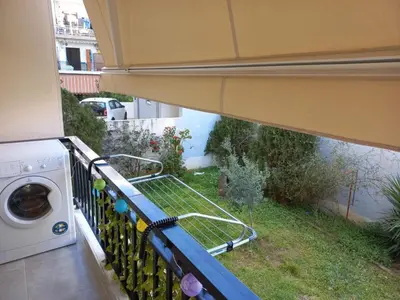 a balcony with a washing machine and a rack of bottles at Chania Town Center with Balcony by MPS in Chania Town
