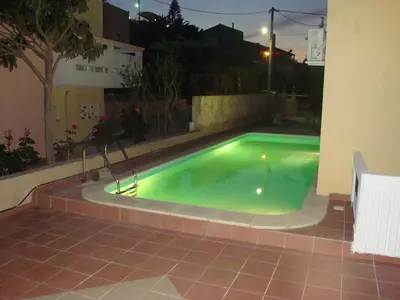 a swimming pool with a statue next to a building at Anniko in Stalos