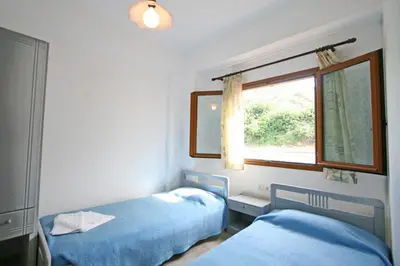 a bedroom with two beds and a window at Anniko in Stalos