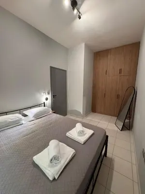 a bedroom with a bed with towels on it at Unique Apartment 3 in Chania Town