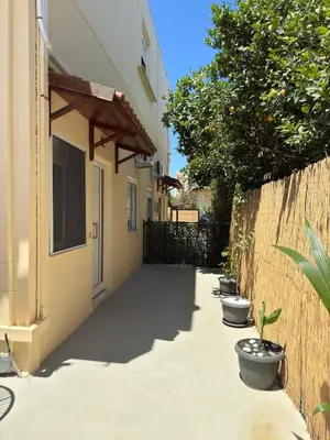 a walkway with potted plants next to a building at Unique Apartment 3 in Chania Town