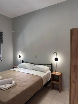 a bedroom with a bed with two lamps on it at Unique Apartment 2 in Chania Town