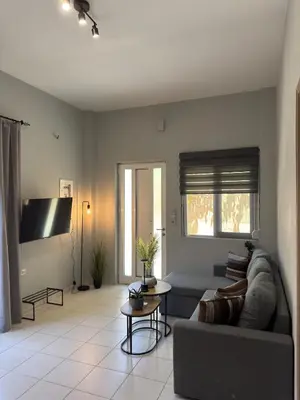 a living room with a couch and a tv at Unique Apartment 2 in Chania Town