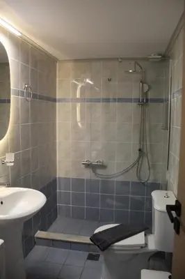 a bathroom with a shower and a toilet and a sink at Unique Apartment 2 in Chania Town