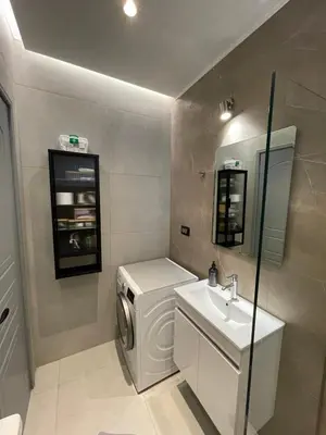 a bathroom with a washing machine and a sink at Pnoé studio, Chania Center in Chania Town