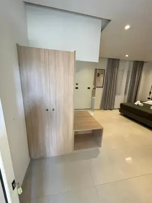 a room with a wooden cabinet and a bed at Pnoé studio, Chania Center in Chania Town