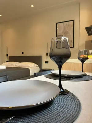 a table with two wine glasses on top of it at Pnoé studio, Chania Center in Chania Town