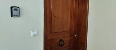 a wooden door in a room with a phone on it at Kaina Villa in Vamos