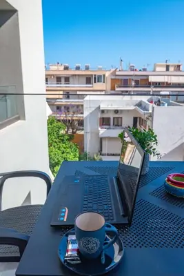 a black table with a laptop and a cup of coffee at Thalo Maison in Chania Town