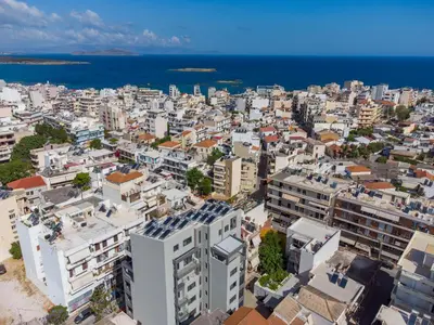 an aerial view of a city with buildings and the ocean at Thalo Maison in Chania Town