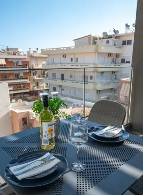 a table with a bottle of wine and a glass at Thalo Maison in Chania Town