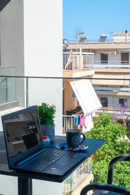 a laptop computer sitting on a table on a balcony at Thalo Maison in Chania Town