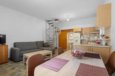 a kitchen and living room with a table and a couch at Litsa's Maisonette Near Sea - City Center in Chania Town