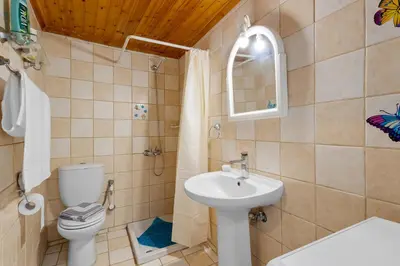 a bathroom with a sink and a toilet and a mirror at Litsa's Maisonette Near Sea - City Center in Chania Town